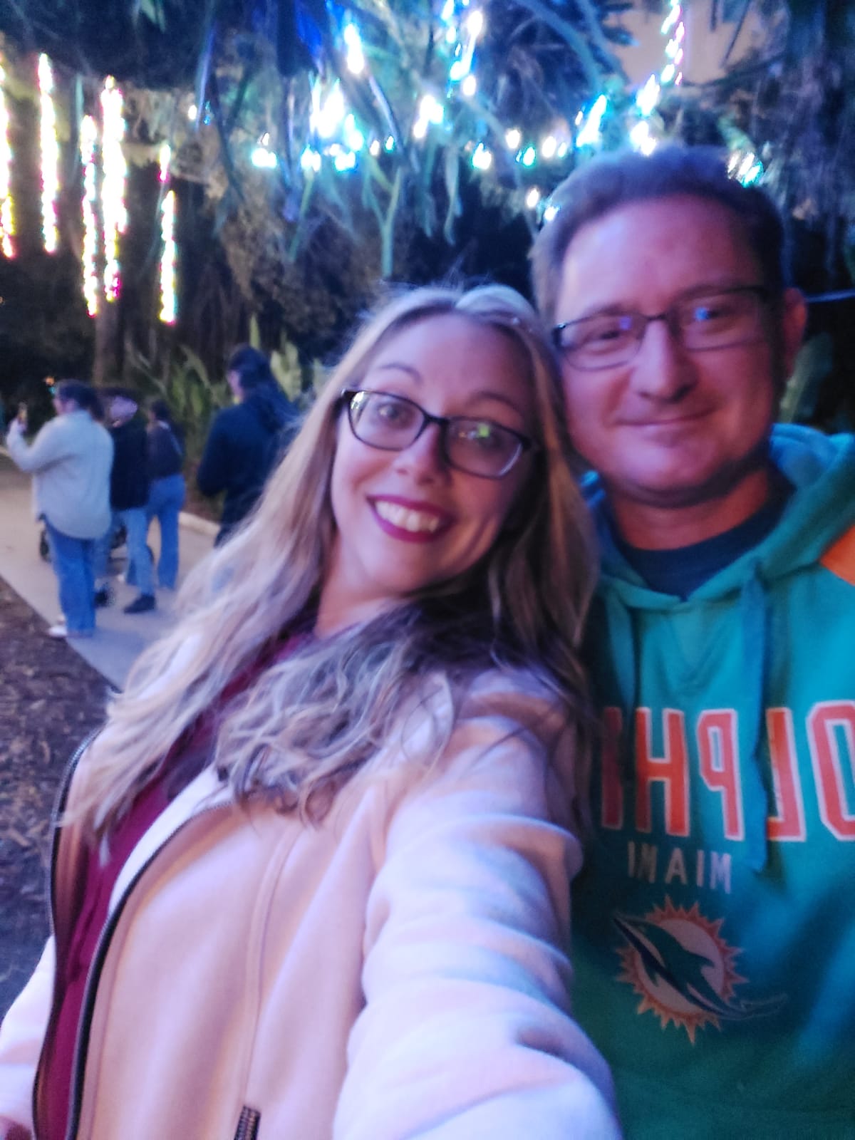 Justin and Shaina together beneath festive evening lights